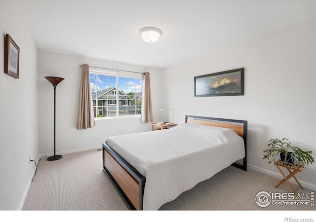 carpeted bedroom featuring baseboards