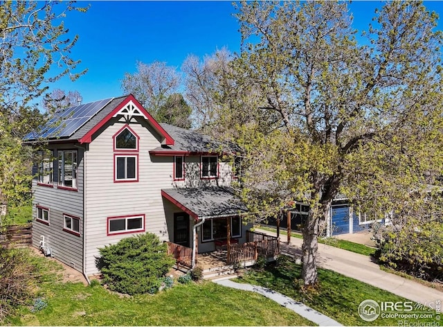 victorian-style house with a porch and roof mounted solar panels