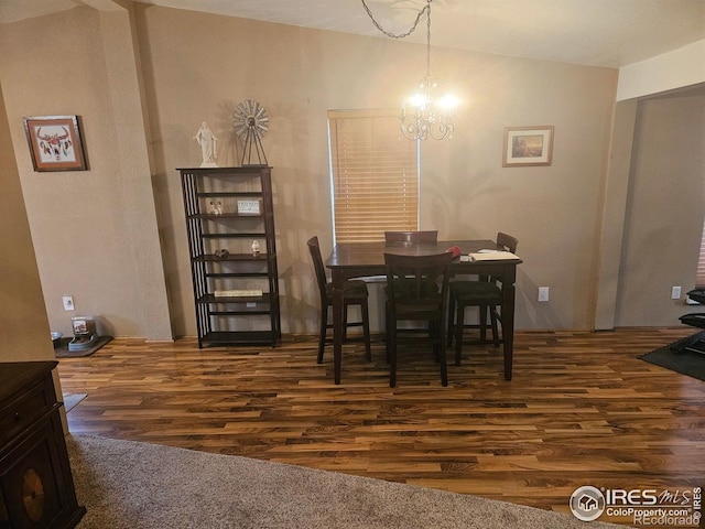 dining space featuring an inviting chandelier and wood finished floors