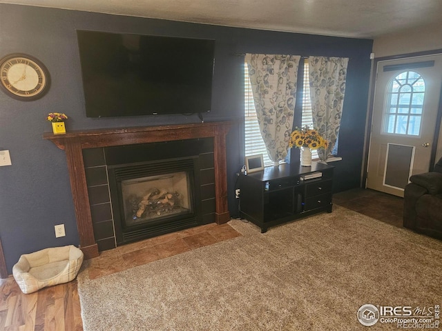 living room featuring a tile fireplace