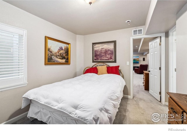 bedroom featuring light carpet, baseboards, and visible vents
