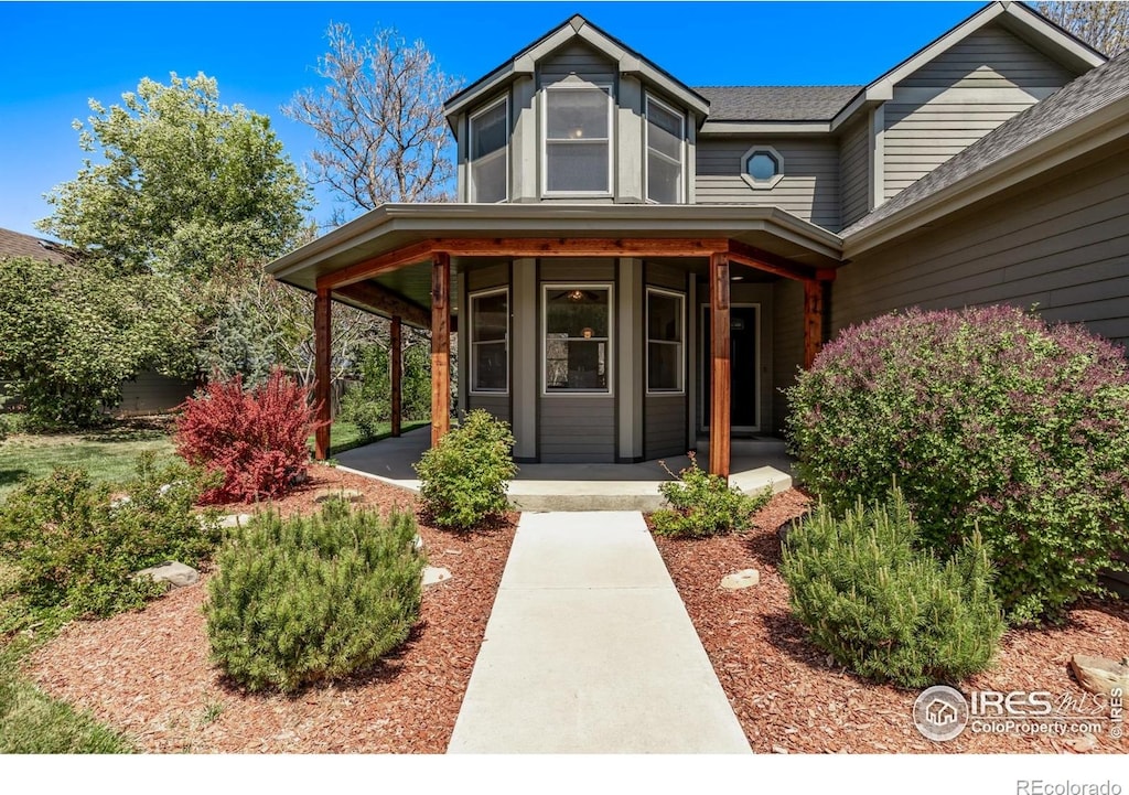 5137 W 12th St, Greeley, CO 80634 - entrance to property with a shingled roof and covered porch