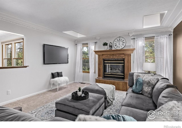 living area with carpet flooring, baseboards, a fireplace, and ornamental molding