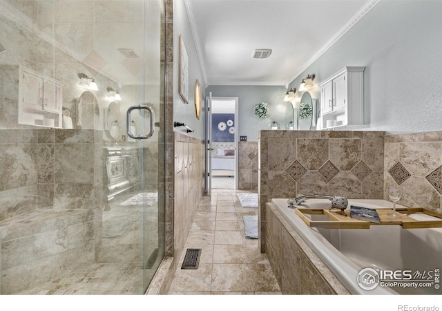 full bathroom with a shower stall, tile walls, crown molding, and visible vents