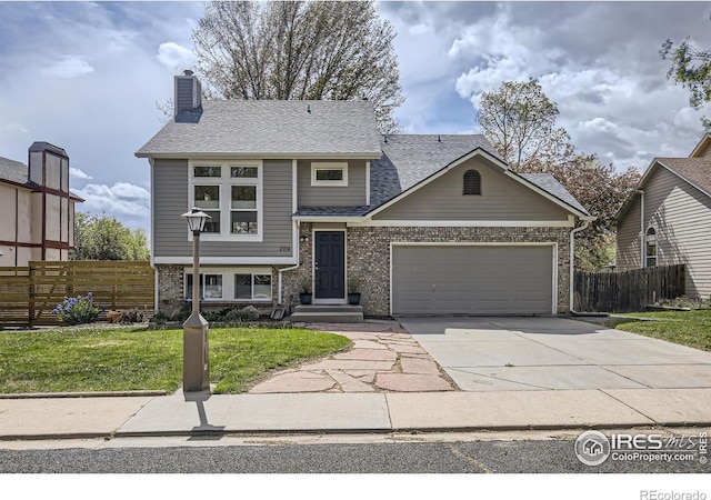 709 Buchanan Ln, Longmont, CO 80504 - view of front facade with an attached garage, concrete driveway, a chimney, and brick siding