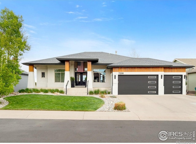 7230 Spanish Bay Dr, Windsor, CO 80550 - prairie-style house featuring an attached garage, a front yard, driveway, and stucco siding
