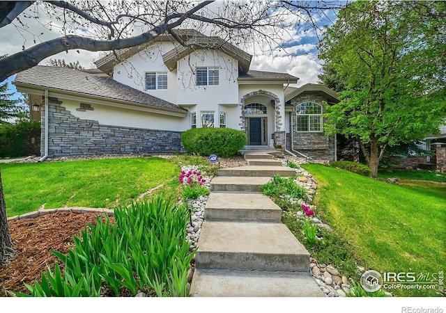 2206 Eagles Nest Dr, Lafayette, CO 80026 - view of front of home with stone siding, stucco siding, and a front lawn