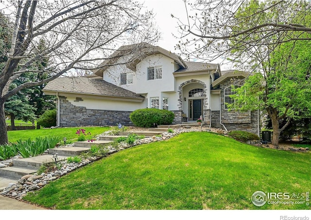 2206 Eagles Nest Dr, Lafayette, CO 80026 - traditional home with stucco siding, stone siding, and a front yard