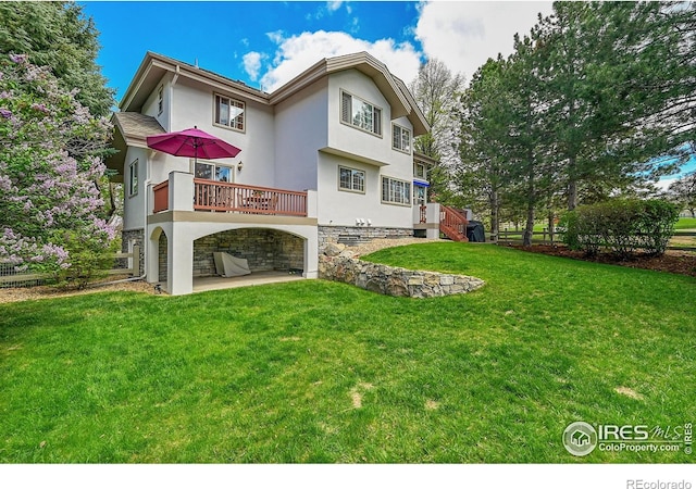 2206 Eagles Nest Dr, Lafayette, CO 80026 - rear view of property featuring a lawn, a patio area, stucco siding, and stone siding