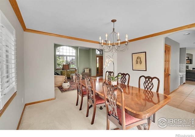 2206 Eagles Nest Dr, Lafayette, CO 80026 - dining room with light colored carpet, an inviting chandelier, baseboards, and ornamental molding