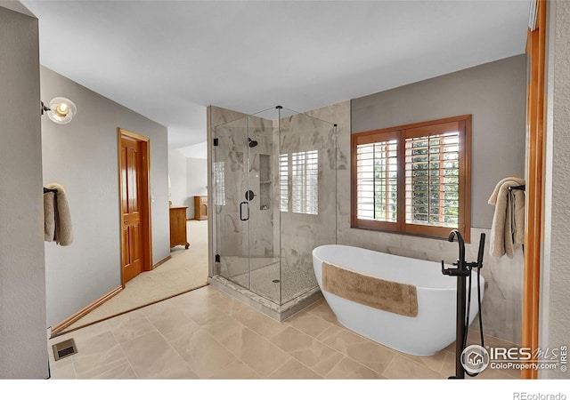 2206 Eagles Nest Dr, Lafayette, CO 80026 - bathroom featuring a stall shower, visible vents, and a freestanding tub
