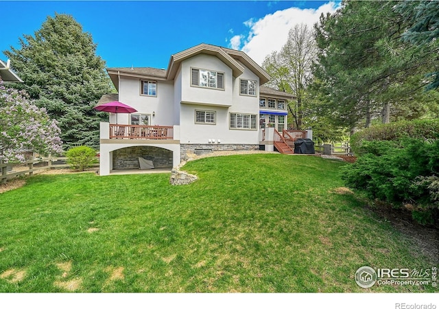 2206 Eagles Nest Dr, Lafayette, CO 80026 - rear view of property featuring a yard, stucco siding, stairway, and a deck