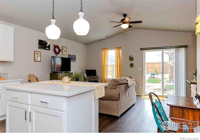 506 Bobcat Ct, Wiggins, CO 80654 - living area with dark wood-style floors, a ceiling fan, and vaulted ceiling