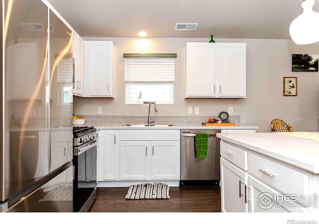 506 Bobcat Ct, Wiggins, CO 80654 - kitchen featuring appliances with stainless steel finishes, a sink, white cabinets, and dark wood finished floors