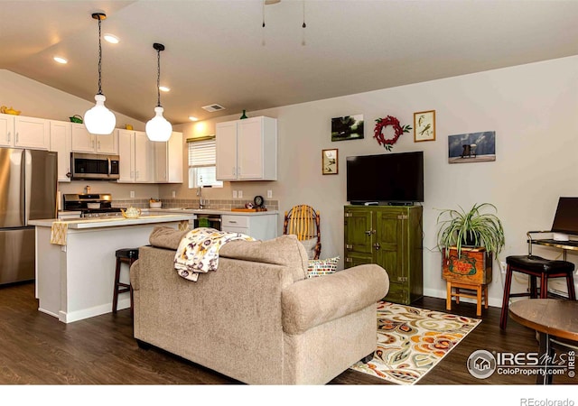 506 Bobcat Ct, Wiggins, CO 80654 - living room featuring dark wood-style flooring, baseboards, recessed lighting, and lofted ceiling