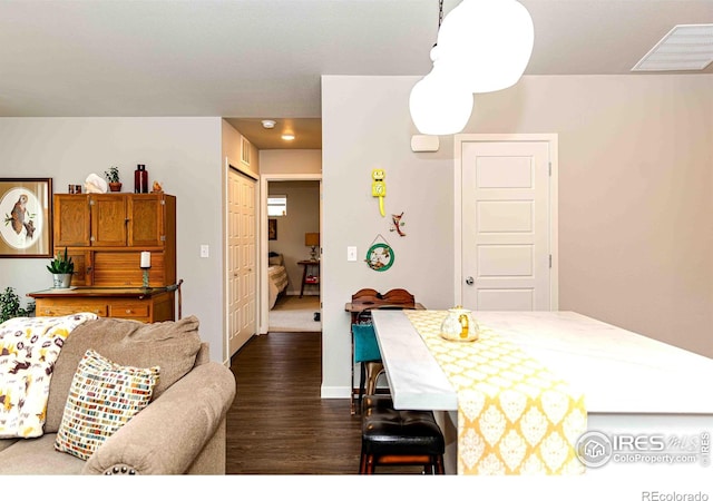 506 Bobcat Ct, Wiggins, CO 80654 - dining space with dark wood-style flooring and baseboards