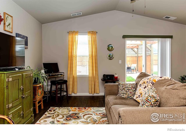 506 Bobcat Ct, Wiggins, CO 80654 - living area with vaulted ceiling, dark wood-style floors, ceiling fan, and baseboards