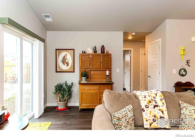 506 Bobcat Ct, Wiggins, CO 80654 - living area with dark wood finished floors, plenty of natural light, and baseboards