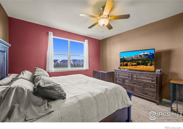 carpeted bedroom featuring a ceiling fan