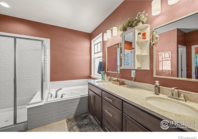 bathroom featuring a stall shower, a garden tub, double vanity, and tile patterned floors