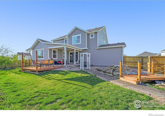 rear view of house featuring a wooden deck