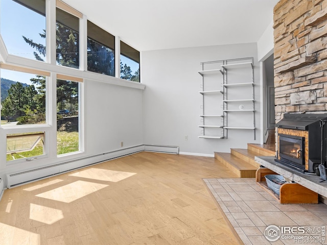 1411 Vail Ct, Estes Park, CO 80517 - unfurnished living room with wood finished floors, baseboard heating, and baseboards