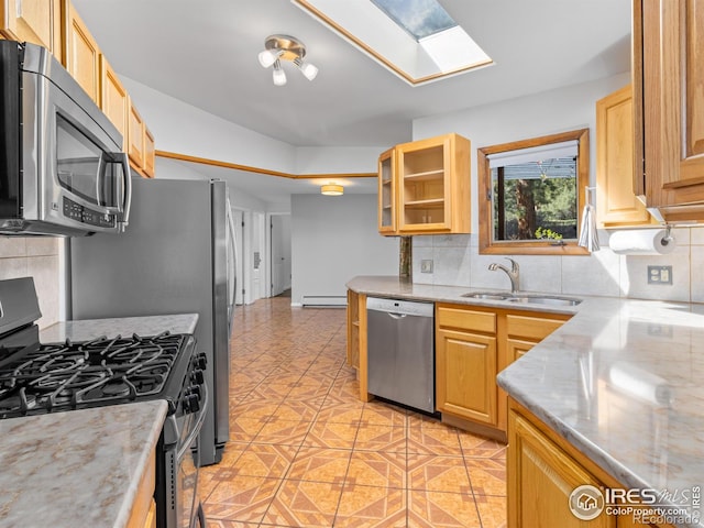 1411 Vail Ct, Estes Park, CO 80517 - kitchen featuring appliances with stainless steel finishes, baseboard heating, a sink, a skylight, and tasteful backsplash