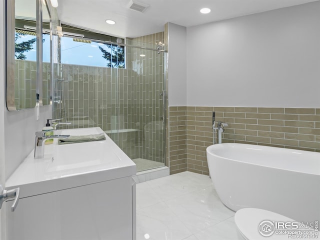 1411 Vail Ct, Estes Park, CO 80517 - bathroom with a shower stall, tile walls, a freestanding bath, recessed lighting, and vanity