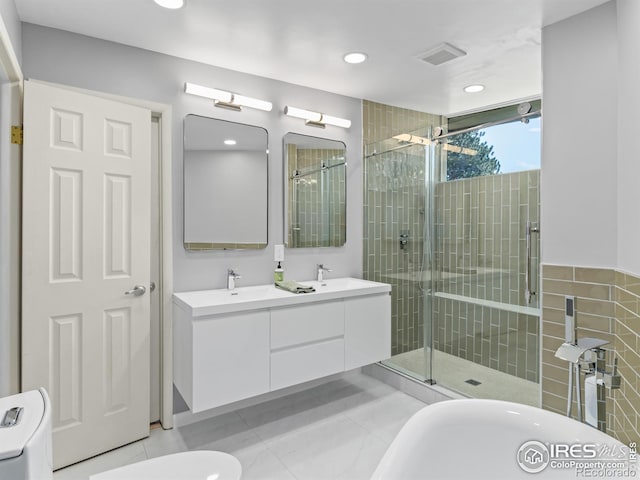 1411 Vail Ct, Estes Park, CO 80517 - bathroom featuring a stall shower, double vanity, a freestanding bath, tile patterned flooring, and recessed lighting