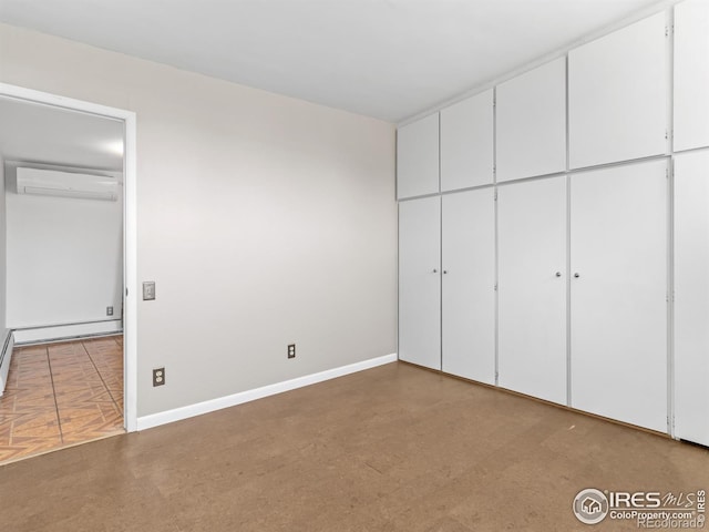 1411 Vail Ct, Estes Park, CO 80517 - unfurnished bedroom with a wall unit AC, baseboards, and a closet