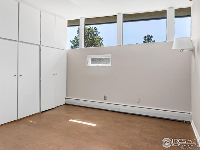 1411 Vail Ct, Estes Park, CO 80517 - unfurnished bedroom with baseboard heating and wood finished floors
