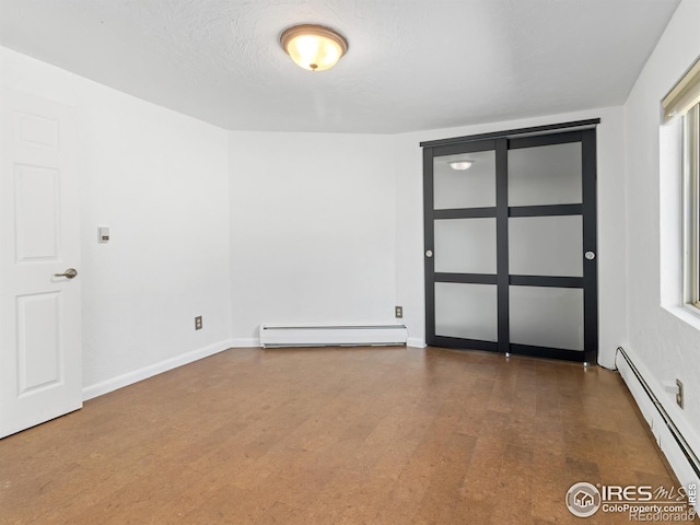 1411 Vail Ct, Estes Park, CO 80517 - spare room with a baseboard radiator, a baseboard heating unit, wood finished floors, and baseboards