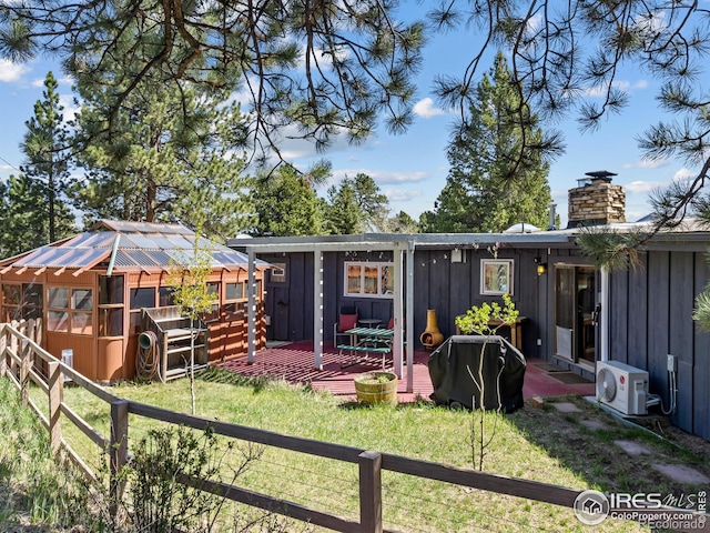1411 Vail Ct, Estes Park, CO 80517 - back of property featuring board and batten siding, a cooling unit, a deck, and a chimney
