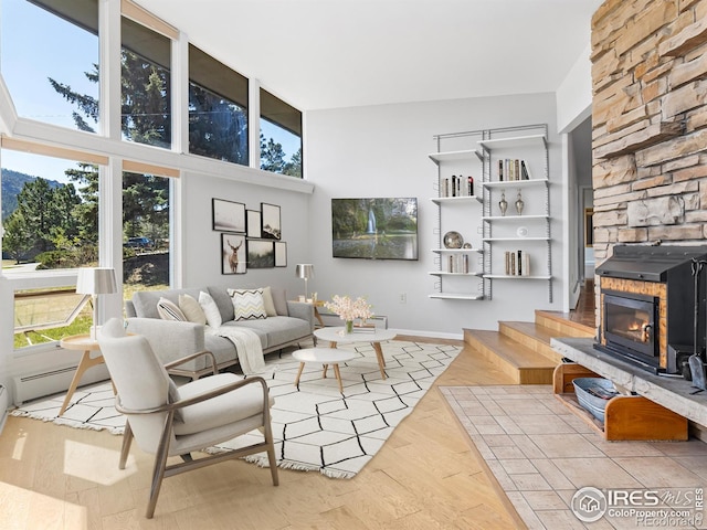 1411 Vail Ct, Estes Park, CO 80517 - living area featuring a high ceiling, wood finished floors, and baseboards