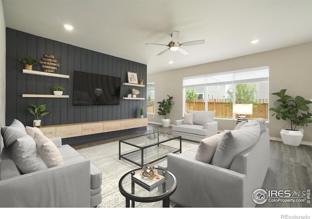 living area with a ceiling fan, wood finished floors, baseboards, and recessed lighting
