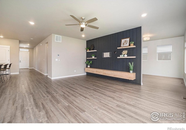 unfurnished living room featuring a ceiling fan, recessed lighting, visible vents, and wood finished floors