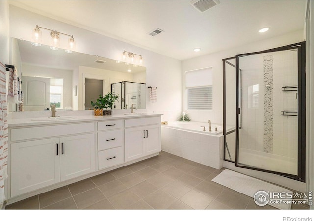 bathroom featuring a sink, a stall shower, and visible vents