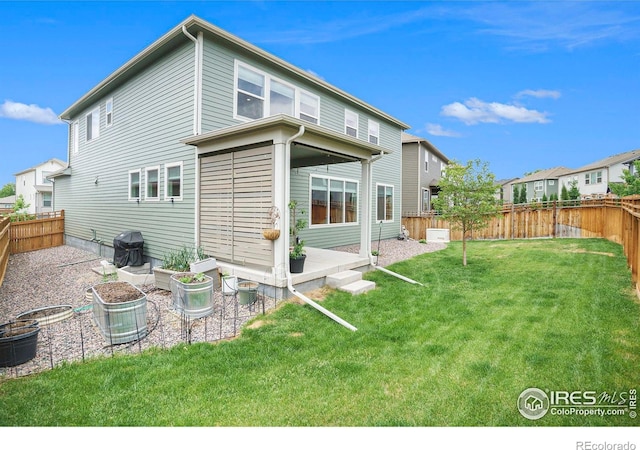 back of property with a yard, a patio, and a fenced backyard