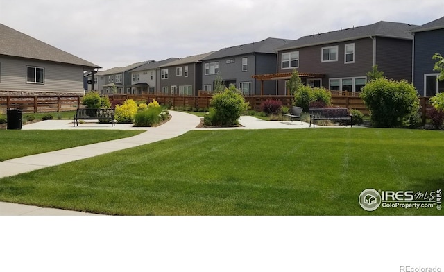 view of yard with fence and a residential view
