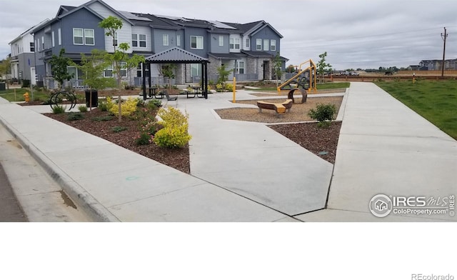 view of home's community with playground community, a gazebo, and a residential view