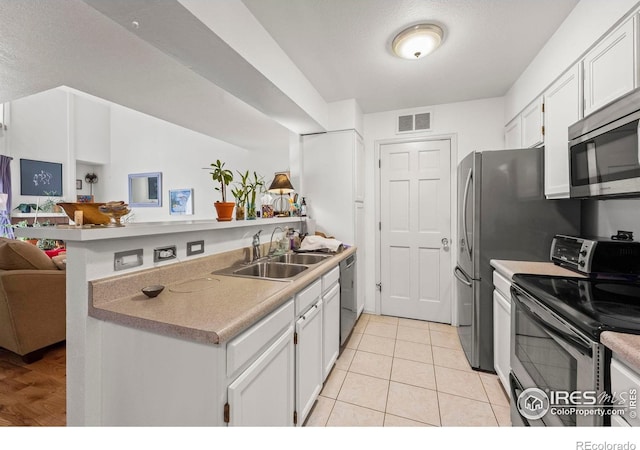 5086 Buckingham Rd, Boulder, CO 80301 - kitchen featuring appliances with stainless steel finishes, a sink, open floor plan, a peninsula, and white cabinets
