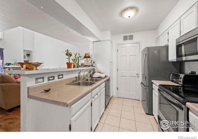 5086 Buckingham Rd, Boulder, CO 80301 - kitchen with stainless steel appliances, a sink, a peninsula, white cabinets, and open floor plan