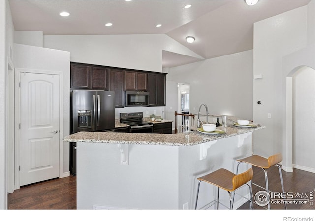 9137 Harlequin Cir, Frederick, CO 80504 - kitchen featuring stainless steel range with electric cooktop, a kitchen breakfast bar, refrigerator with ice dispenser, vaulted ceiling, and dark wood-style flooring