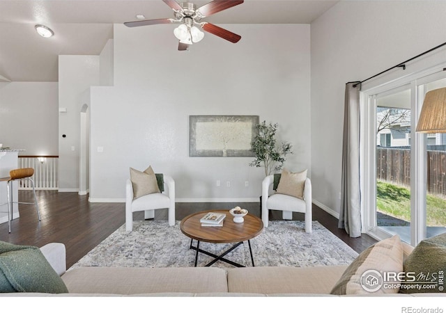 9137 Harlequin Cir, Frederick, CO 80504 - living area with wood finished floors, high vaulted ceiling, arched walkways, a ceiling fan, and baseboards