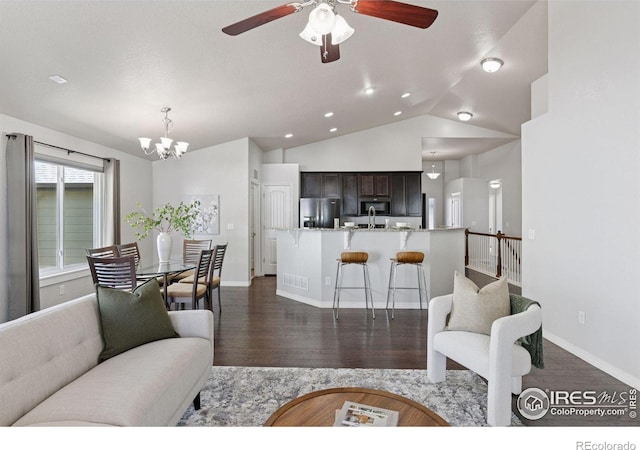 9137 Harlequin Cir, Frederick, CO 80504 - living room with dark wood-style floors, a chandelier, ceiling fan, lofted ceiling, and baseboards
