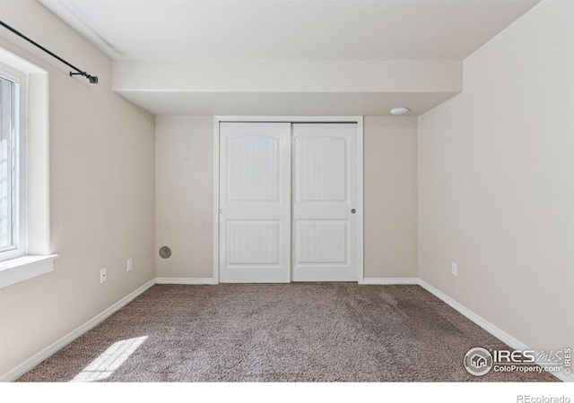 9137 Harlequin Cir, Frederick, CO 80504 - unfurnished bedroom with carpet floors, a closet, and baseboards