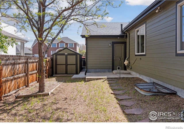 9137 Harlequin Cir, Frederick, CO 80504 - view of yard featuring fence, a storage unit, an outbuilding, and entry steps