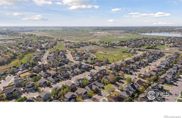 9137 Harlequin Cir, Frederick, CO 80504 - aerial view of property and surrounding area featuring a large body of water and nearby suburban area