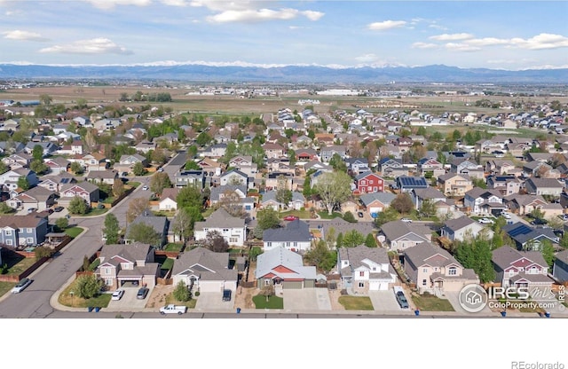9137 Harlequin Cir, Frederick, CO 80504 - aerial view of property and surrounding area with a mountain backdrop and nearby suburban area