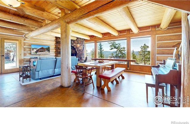 dining area featuring wood ceiling, log walls, concrete flooring, and beamed ceiling
